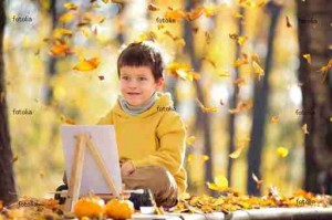 Cute five years old boy having fun in autumn park